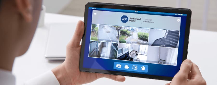 Homeowner viewing live camera feeds on a tablet